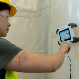 Worker using Omni IQ G720 mounted on containment wall